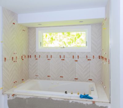 Construction installing ceramic tile on reconstruction of bathroom during or renovation