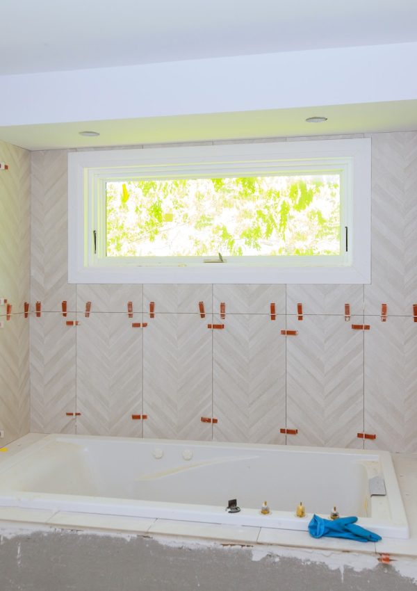 Construction installing ceramic tile on reconstruction of bathroom during or renovation